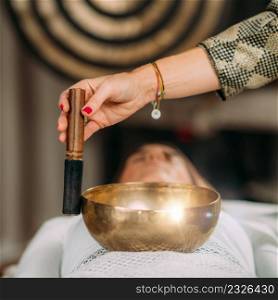 Tibetan singing bowl in sound healing therapy. Sound Therapy with Tibetan Singing Bowl