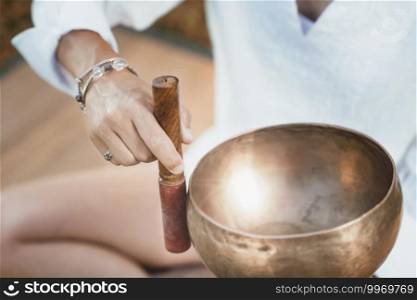 Tibetan singing bowl in sound therapy close up. Sound Therapy with Tibetan Singing Bowl