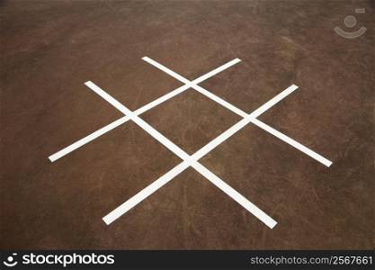Tic tac toe game on playground concrete.