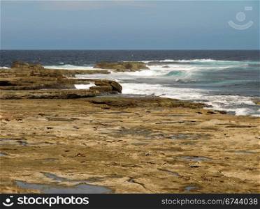 Tidal rock platform, Australia. Tidal rock platform in australia with ocean in the background and neutral sky