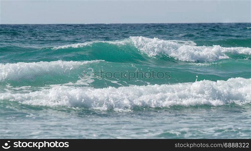 Tidal waves at sea. Beautiful tidal waves against the sky
