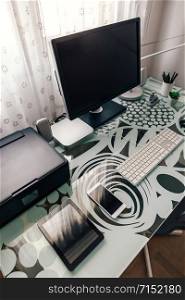 Tidy workstation with table and technological devices. Workstation with table, computer and printer