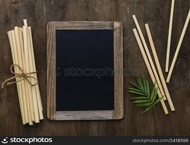 tied bamboo organic straws copy space blackboard frame