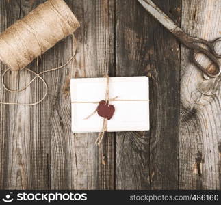 tied up with a rope a stack of empty cards on a gray wooden table, top view