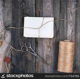 tied up with a rope a stack of empty cards on a gray wooden table, top view