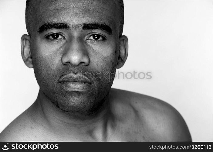 Tight face portrait of serious African-Amercan man.