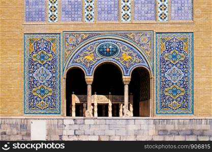 Tile art on the wall of Karim Khani Nook with a small marble throne inside the terrace. Golestan palace, Tehran, Iran.