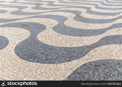 Tile brick floor in Lisbon Town Square, Portugal using as background