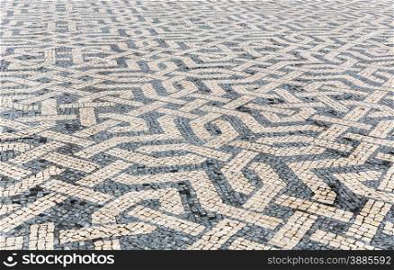 Tile brick floor in Lisbon Town Square, Portugal using as background