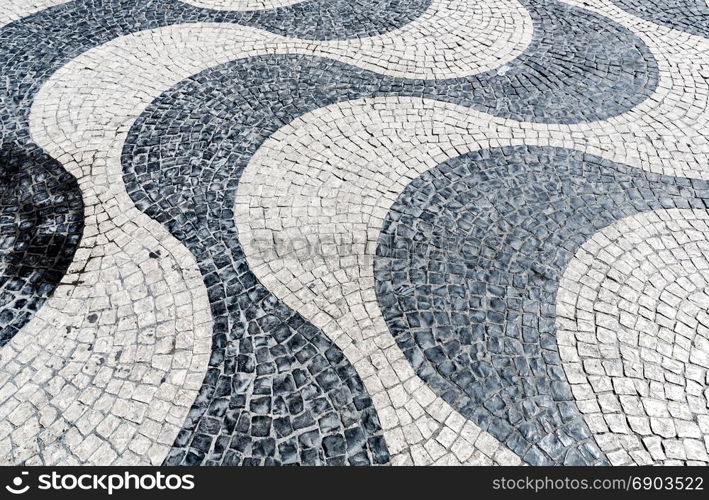 Tile brick floor in Lisbon Town Square, Portugal using as background