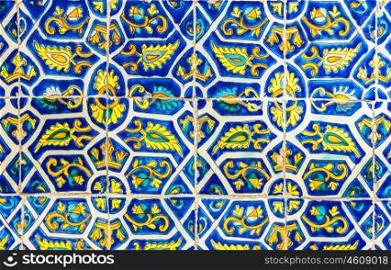 Tiled abstract background, beautiful blue and yellow decorated tile, vintage porcelain, ancient wall in the church, traditional Mexican floral pattern, art and architecture concept