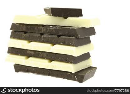 Tiles of dark and white chocolate isolated on white