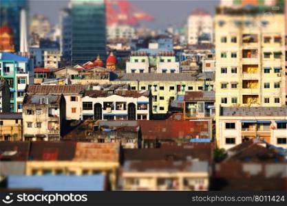 Tilt shift blur effect. Futuristic aerial view panorama of developing Yangon city. Myanmar (Burma)