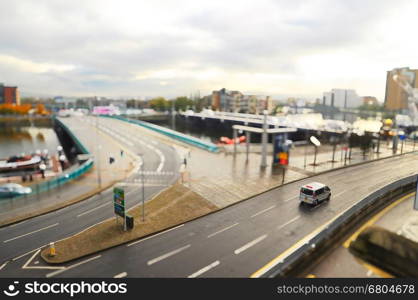 Tilt shift image of city with car on the street.