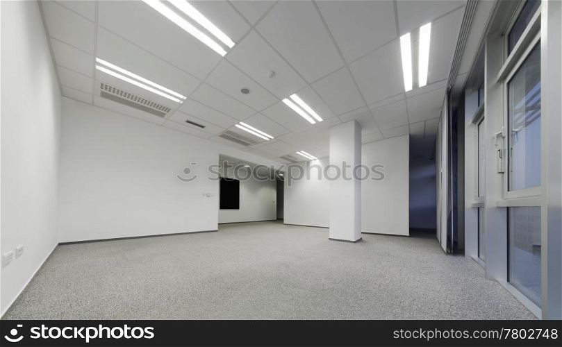 Tilt shift image of empty modern white office ready to rent