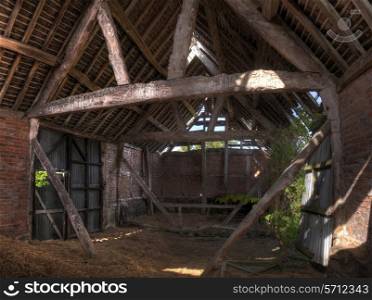 Timber-frame and brick constructed English barn interior.