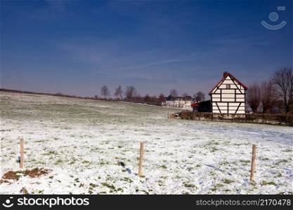 Timber framed house in a snow covered landscape in the Dutch hamlet Terziet near Epen. Timber framed house in a snow covered landscape