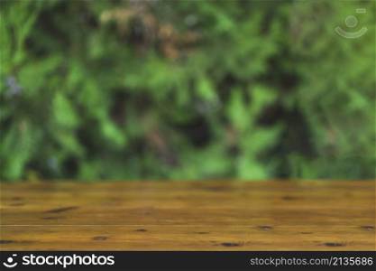 timber tabletop blurred green background