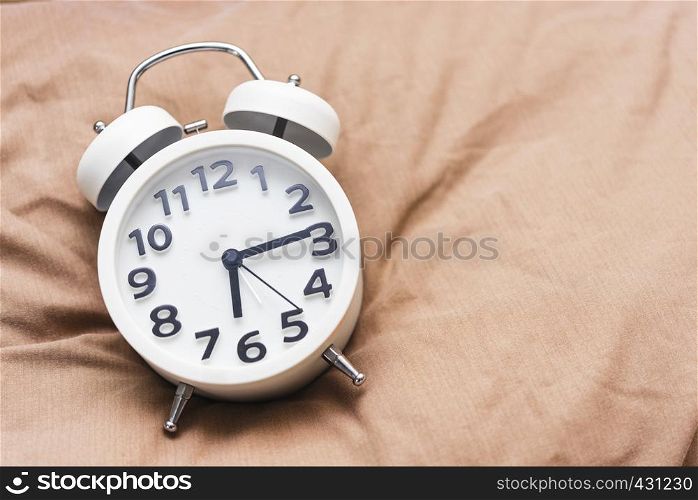 Time background concept. Alarm clock on bed, wake up in the morning. Picture for add text message. Backdrop for design art work.