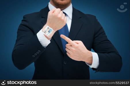 time, business and new technology concept - close up of businessman pointing to something at his hand