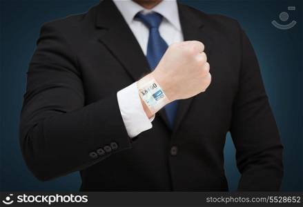 time, business and new technology concept - close up of businessman showing something at his hand