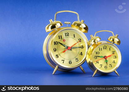 Time concept - alarm clock against colorful background