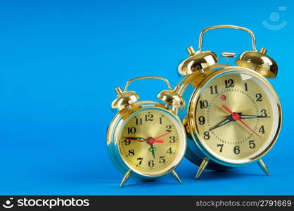 Time concept - alarm clock against colorful background