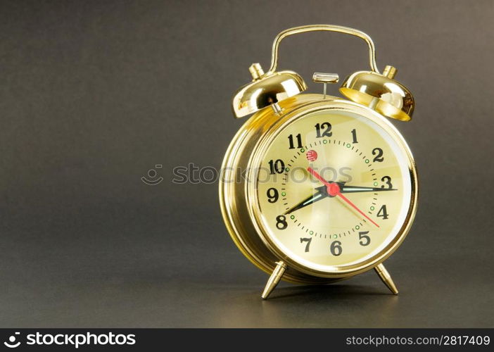 Time concept - alarm clock against colorful background