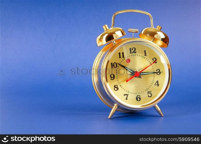 Time concept - alarm clock against colorful background