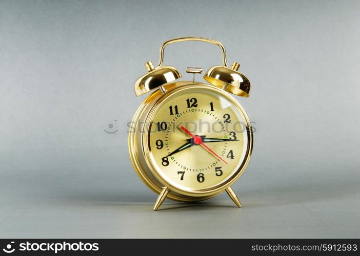 Time concept - alarm clock against colorful background