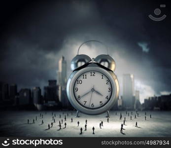 Time concept. Big old-style clock and many businesspeople around