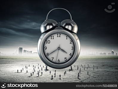 Time concept. Big old-style clock and many businesspeople around