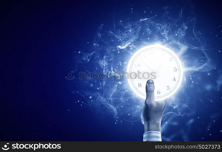 Time concept. Close up image of human hand with alarm clock