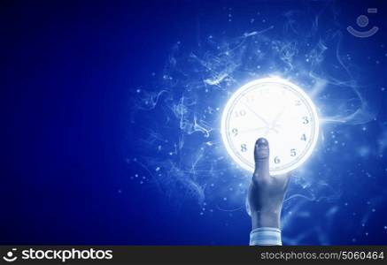Time concept. Close up image of human hand with alarm clock