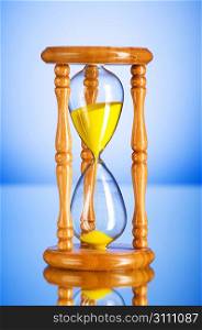 Time concept - hourglass against the gradient background