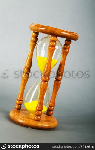 Time concept - hourglass against the gradient background