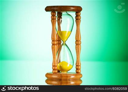 Time concept - hourglass against the gradient background