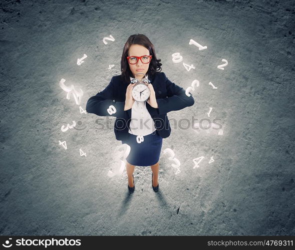 Time concept. Top view of businesswoman holding alarm clock