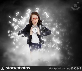 Time concept. Top view of excited businesswoman holding alarm clock