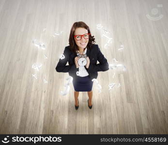 Time concept. Top view of smiling businesswoman holding alarm clock