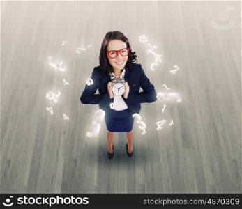 Time concept. Top view of smiling businesswoman holding alarm clock