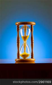Time concept with hourglass against background