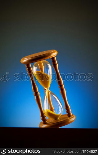 Time concept with hourglass against background