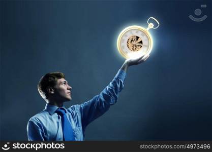 Time concept. Young businessman holding pocket watch in hand