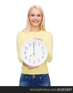 time, education and people concept - smiling young woman with wall clock showing 8