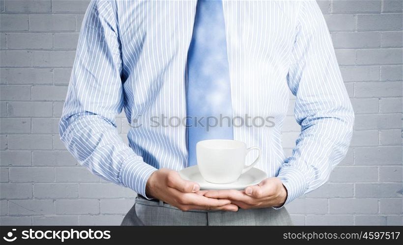 Time for break. Close up of businessman hand holding white cup