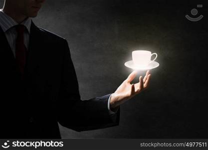 Time for break. Close up of businessman hand holding white cup