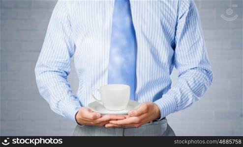Time for break. Close up of businessman holding in hands white cup