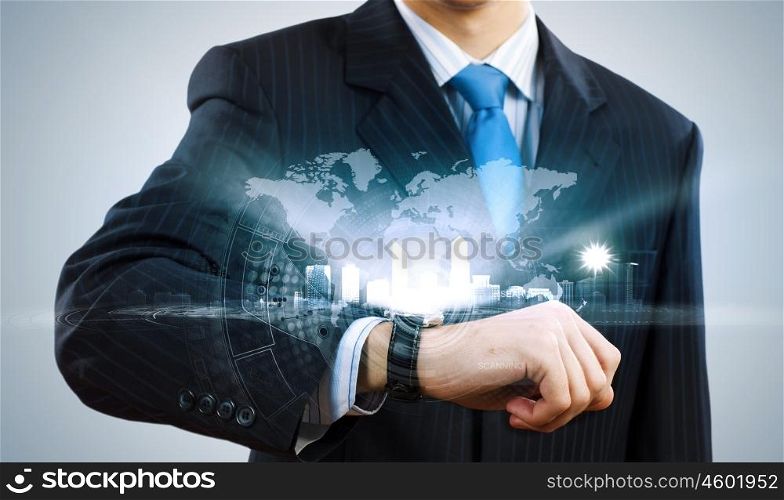 Time for business. Businessman looking at wristwatch. Media technologies and innovations