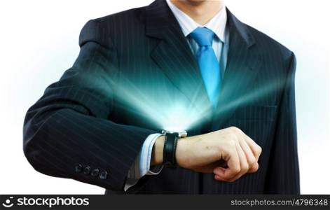Time for business. Businessman looking at wristwatch. Media technologies and innovations
